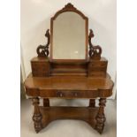 A Victorian mahogany dressing table with mirror. Turned Legs with carved decoration.