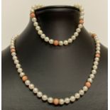 A matching pearl and coral bead necklace and bracelet both with 9ct gold clip clasps.