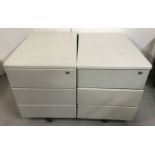 2 modern wheeled 3 drawer units in a pale grey finish.