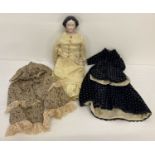 A vintage doll with ceramic head and feet, straw filled cloth body and composite hands.