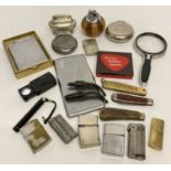 A collection of smoking related items to include table and hand lighters.