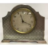 A small Art Deco silver table/bedside clock with chequered engine turned decoration.