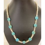 A 20" turquoise and fresh water pearl beaded necklace with pearl set clasp.