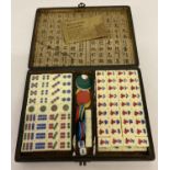 A cased Chinese Mah Jong set complete with instructions, counters dice and blank tiles.