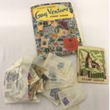A Stanley Gibbons vintage "Gay Venture" stamp album and loose world stamps.