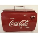 A vintage style painted metal Coca Cola cooler with lift off lid and bottle opener on front.