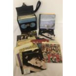A collection of 1960's, 70's and 80's vinyl 7" singles, together with a blue carry case.
