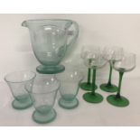 A vintage mint green water jug and 3 matching glasses together with 4 green stemmed hock glasses.