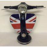 A large table lamp in the shape of the handlebars of a Vespa scooter with Union Jack detail.