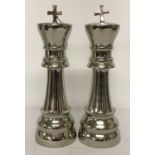 A pair of modern white metal chess piece figurines.