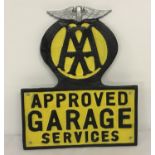 A black and yellow painted cast metal AA Approved Garage Services wall hanging plaque.