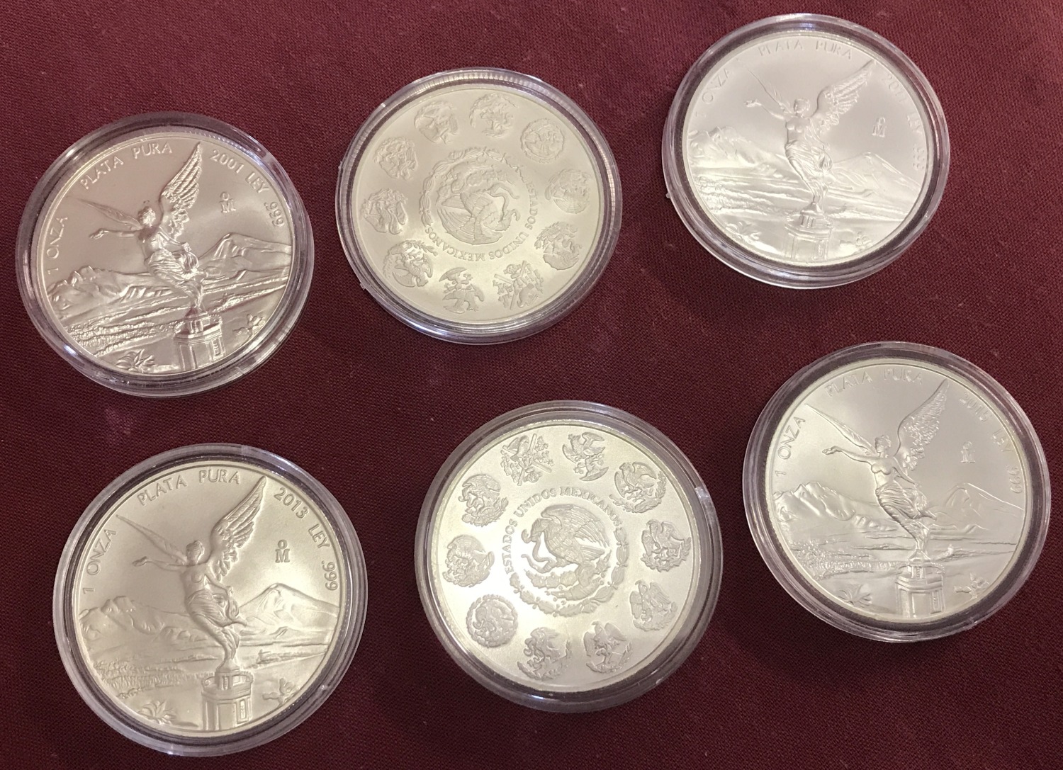 6 uncirculated 999 fine silver, Mexican 1 Onza coins, in plastic cases.