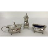3 matching hallmarked silver, 4 footed condiment items. A mustard pot, salt and pepperette.