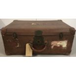 A large vintage suitcase with brass clasps and remnants of a G.W.R baggage label.