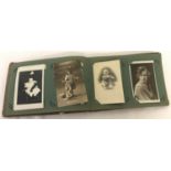 A vintage photograph album containing mainly Edwardian family portraits.