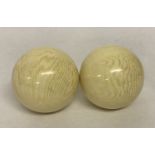 2 white billiard balls, with highly polished finish.