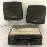 A Sharp RG-2800P classic car radio cassette together with a pair of speakers.