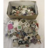 A box of assorted vintage British and foreign loose, used stamps.