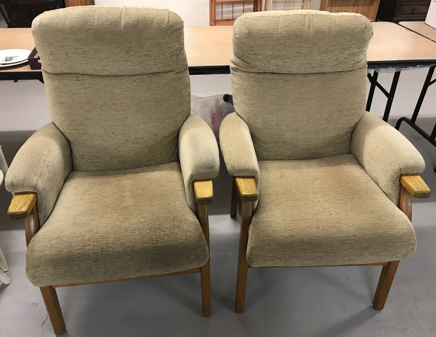 A pair of beige velour Parker Knoll style armchairs with wooden frames.
