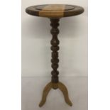 A vintage wooden tripod wine table with turned pedestal.