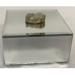 A modern mirrored jewellery box with druzy stone set as lid handle.
