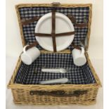 A modern wicker picnic basket with carry handle.