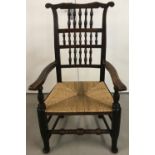 A high back rush seated wooden armchair.