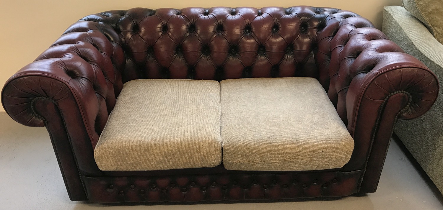 A Thomas Lloyd Ox blood red leather, 2 seater, Chesterfield settee.