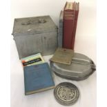 A collection of assorted military related items to include books, medallion and mess tin.