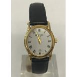 A ladies 18ct gold plated Raymond Weil wristwatch with black leather strap.