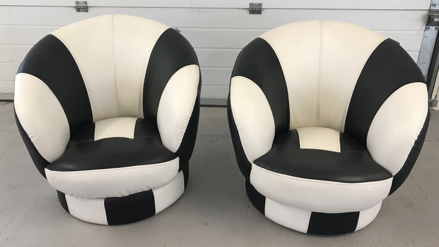 2 matching black and white retro style swivel tub chairs by The Premier Company Ltd.