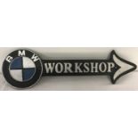 A painted cast iron wall hanging BMW workshop arrow.