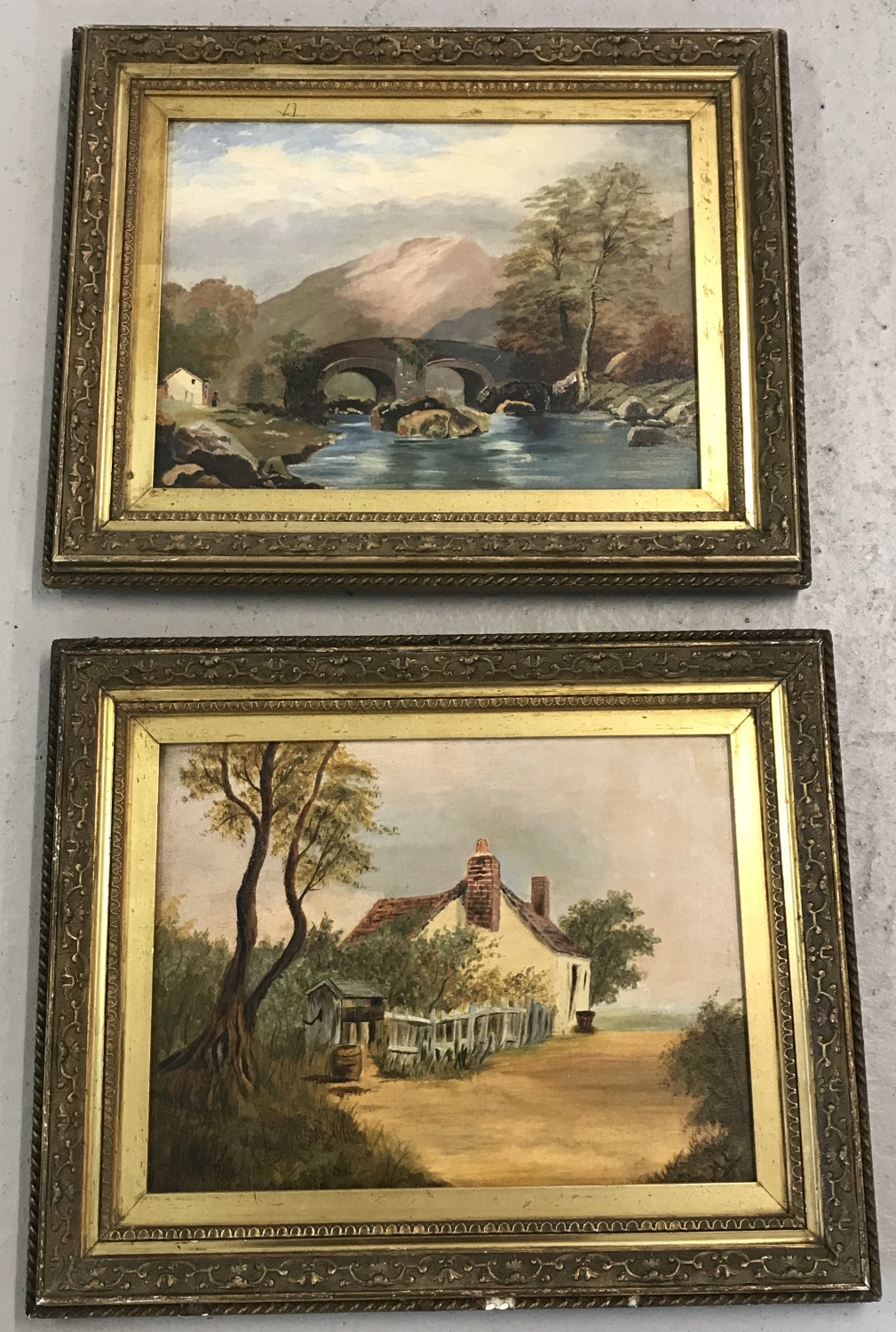 A pair of antique unsigned oil on board paintings in gilt frames.