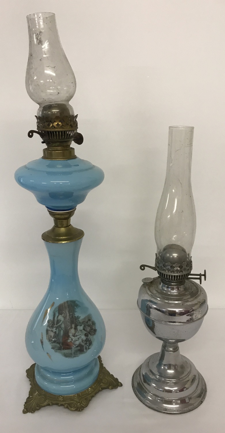 A vintage blue glass 2 tier oil lamp with transfer printed detail to lamp base