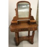 A Victorian mahogany veneer ladies dressing table with turned front legs and carved detail to top.