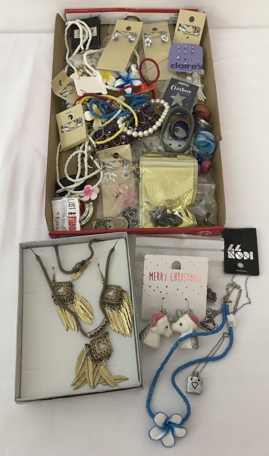 A tray of modern jewellery, some with original cards and packaging.