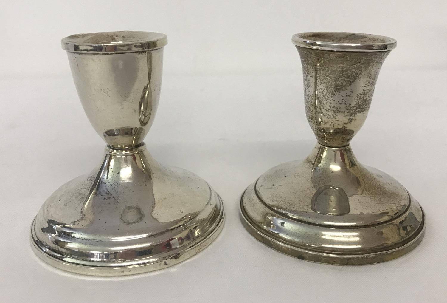 2 sterling silver weighted candlesticks. Circular bases with stepped detail.