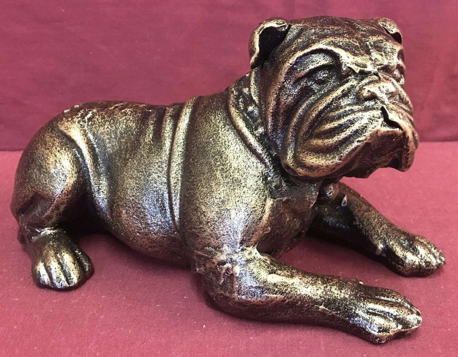 A bronzed cast iron figurine of a Bulldog dog.