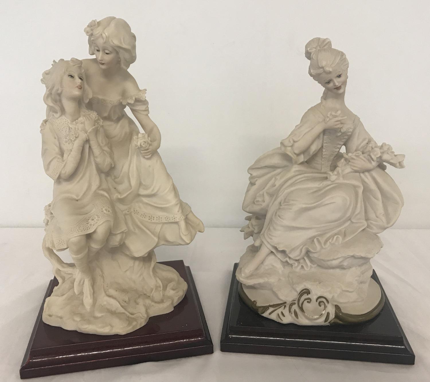 2 Capodimonte figurines mounted on wooden plinths of women in period dress.