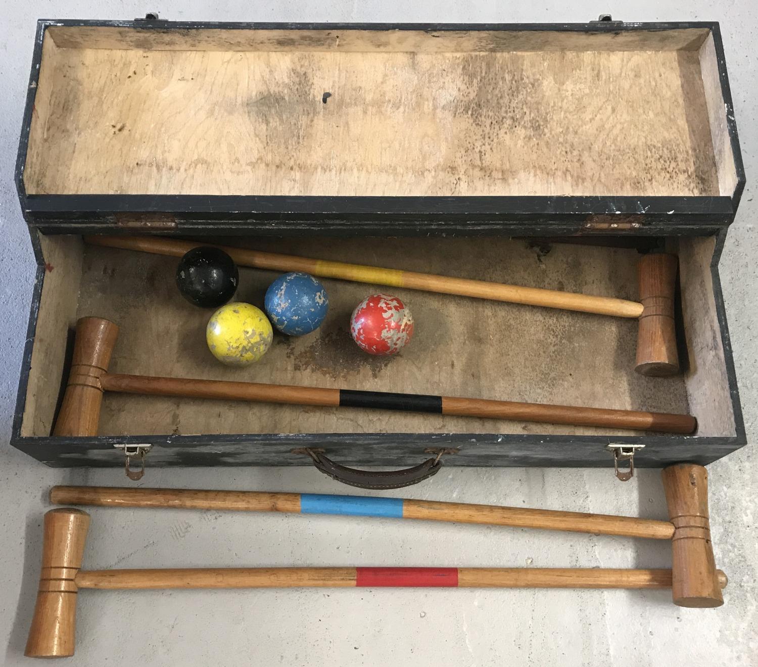 A vintage wooden cased part croquet set; comprising 4 mallets and 4 coloured balls.