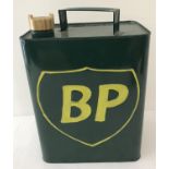 A painted green 2 gallon BP petrol can with brass screw lid.