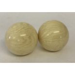 2 white billiard balls, with highly polished finish.