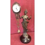 A bronze based figural, swinging pendulum mystery clock.