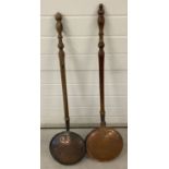 2 antique long wooden handled copper warming pans with turned handles and engraved detail to lids.
