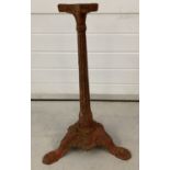 A vintage cast iron pedestal stand for a garden table. With column and classic decoration.