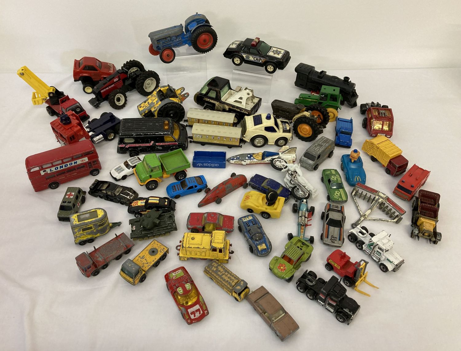 A collection of mixed diecast toy vehicles to include examples by Ertl, Lone Star and Dinky.