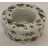 A Chinese ring shaped porcelain lidded trinket pot with hand painted butterfly and floral detail.
