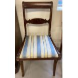 A vintage dark wood Regency style dining chair with upholstered seat.
