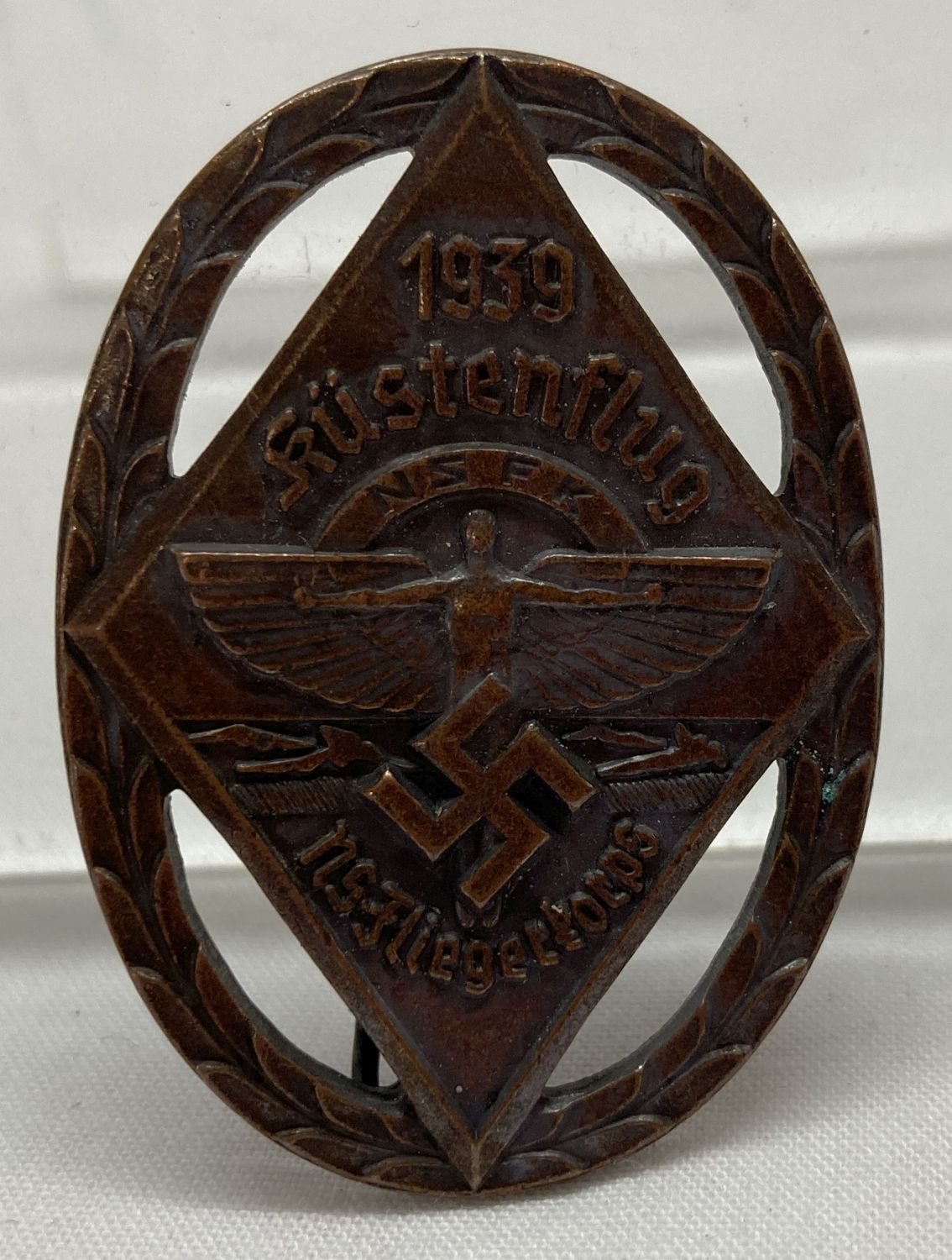 A WWII style N.S.F.K. Rally Flight pin back badge.