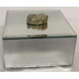 A modern mirrored jewellery box with drusy stone set as lid handle.
